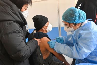 An elderly man receives a COVID-19 vaccine in Qingzhou in China's eastern Shandong province. (Photo ...