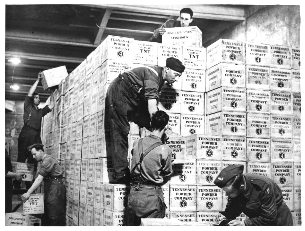 World War II Photo – Cases of TNT and gunpowder shipped from the United States under Lend-Lease are stacked in a tunnel in western England