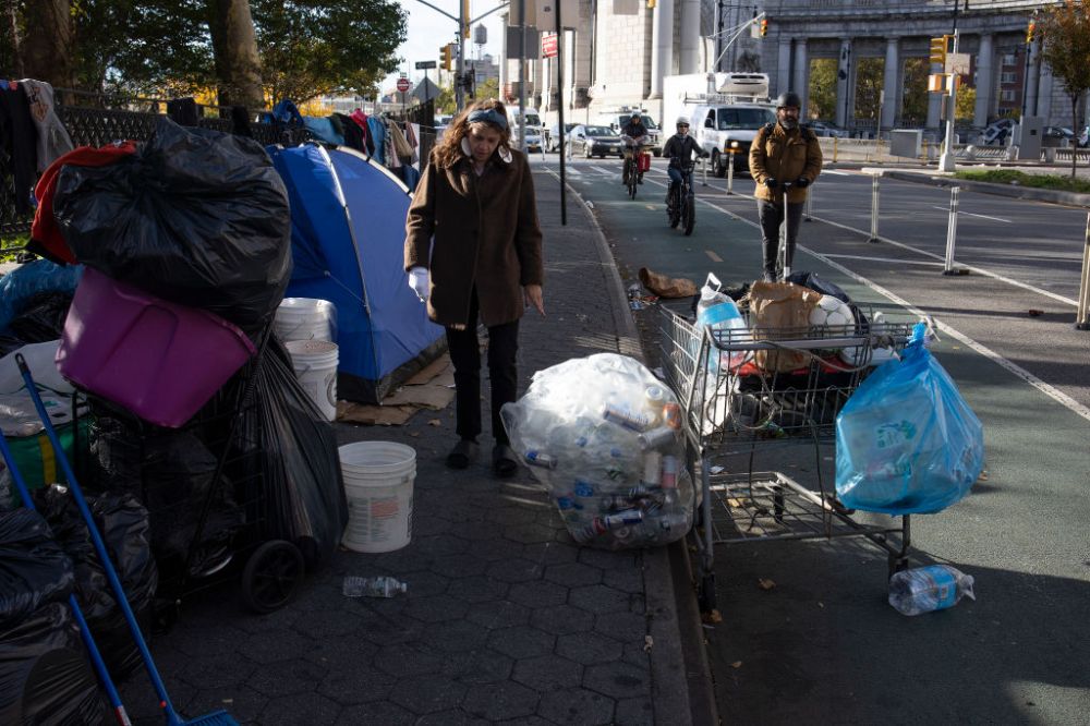 A homeless woman moves her belongings from a New York City encampment. (Photo by Andrew Lichtenstein...
