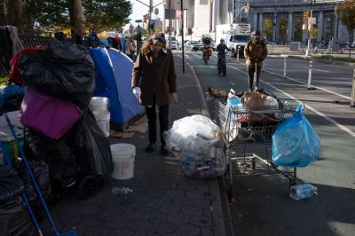 A homeless woman moves her belongings from a New York City encampment. (Photo by Andrew Lichtenstein...