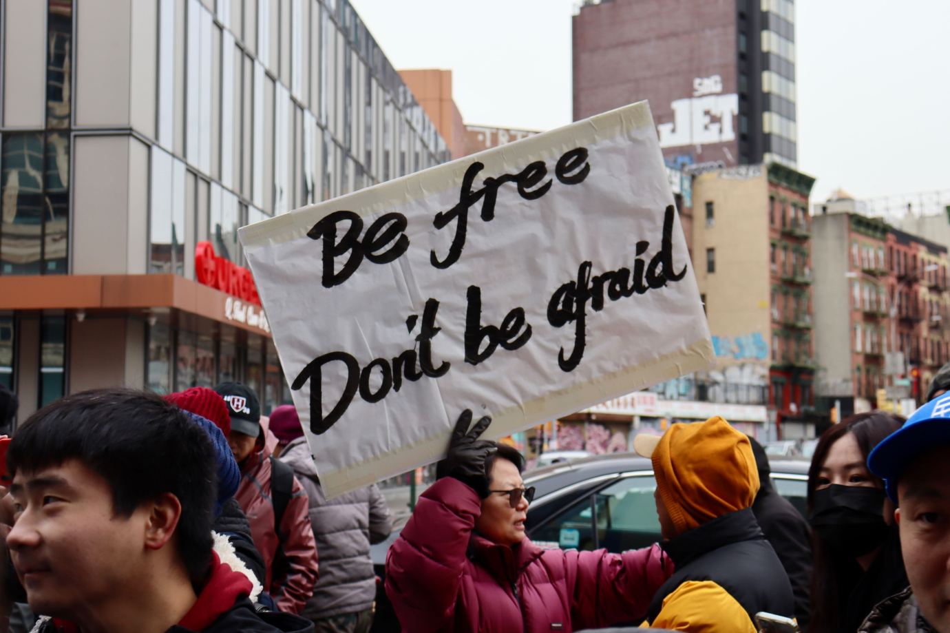 Jing Zhang, former Chinese political prisoner and founder of the organization Women's Rights in China, holds a sign at the rally. (Photo by Haley Byrd Wilt)