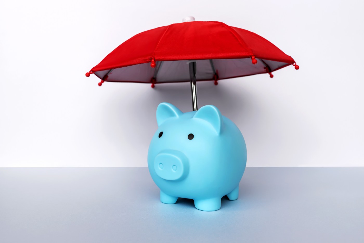 Piggy Bank Red Umbrella – Business and Insurance Concept