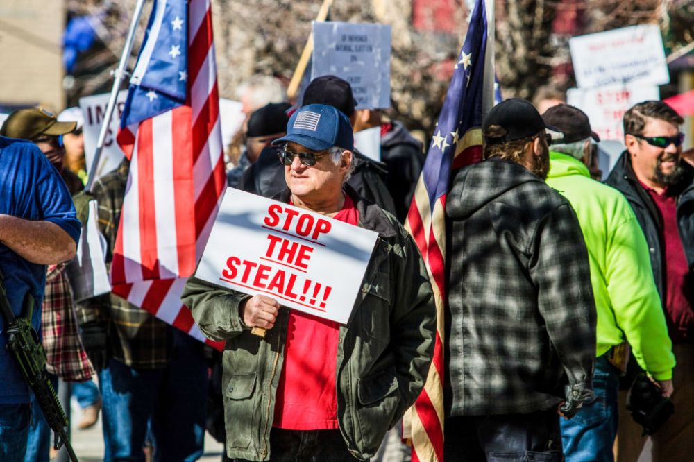 A protestor holds a placard saying Stop the steal during the