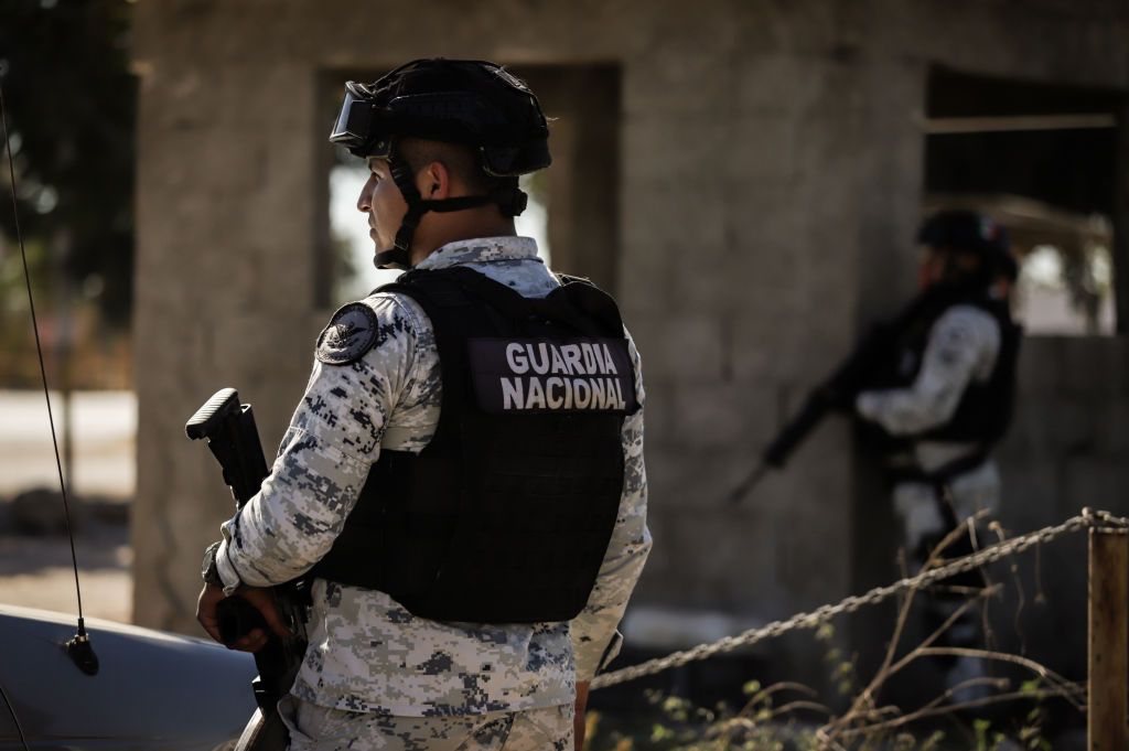 Elements of Mexico's National Guard monitor and protect the perimeter of the Aguaruto Prison. (Photo by Jesus Verdugo/Anadolu Agency via Getty Images)