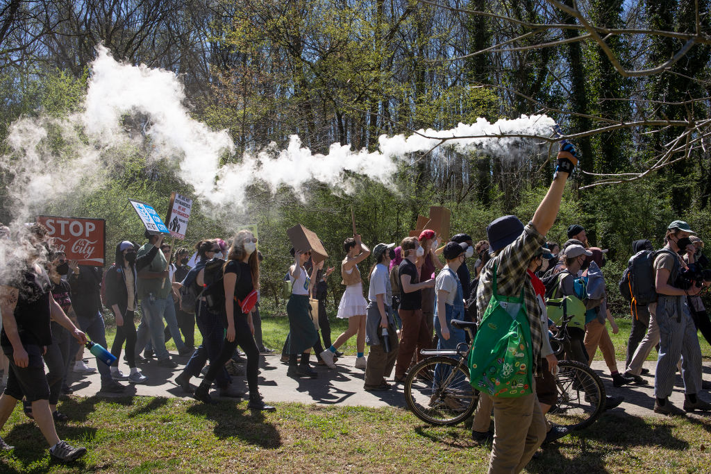 Activists march through a forest that is scheduled to be developed as part of the police training center in Atlanta, Georgia. (Photo by Andrew Lichtenstein/Corbis via Getty Images)