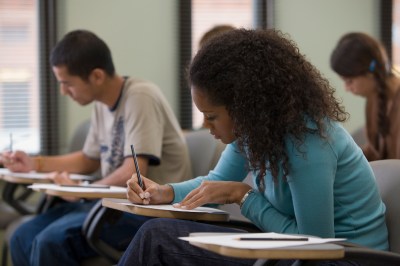 Students taking written examination, side view