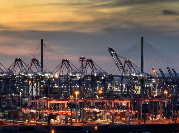 Cranes move shipping containers at the Port of Long Beach