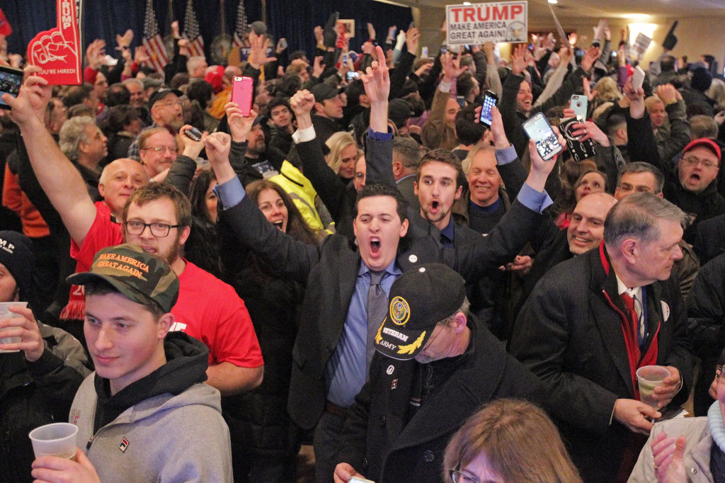 Supporters celebrate as they find out that then-presidential candidate Donald Trump  won the New Hampshire primary during on February 9, 2016. (Photo by Matt Stone/MediaNews Group/Boston Herald via Getty Images)