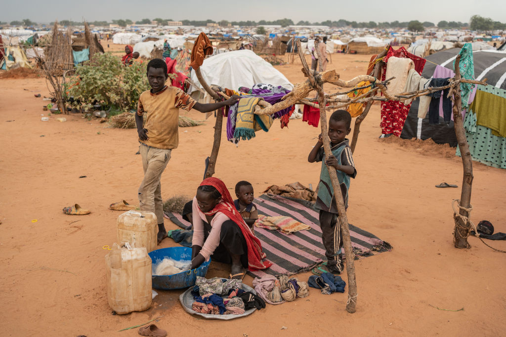 A woman washes clothes at the Adre camp, where around 200,000 people are currently taking refuge on September 19, 2023 in Adre, Chad. The conflict in Sudan, entering its sixth month, has left thousands of civilians dead and displaced more than five million people. (Photo by Abdulmonam Eassa/Getty Images)