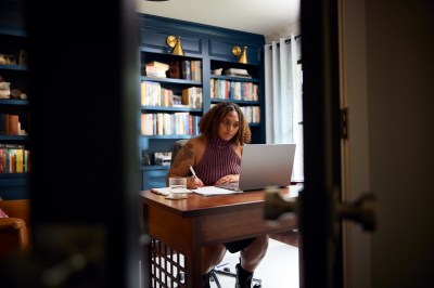 Plus size multi racial woman working in home office