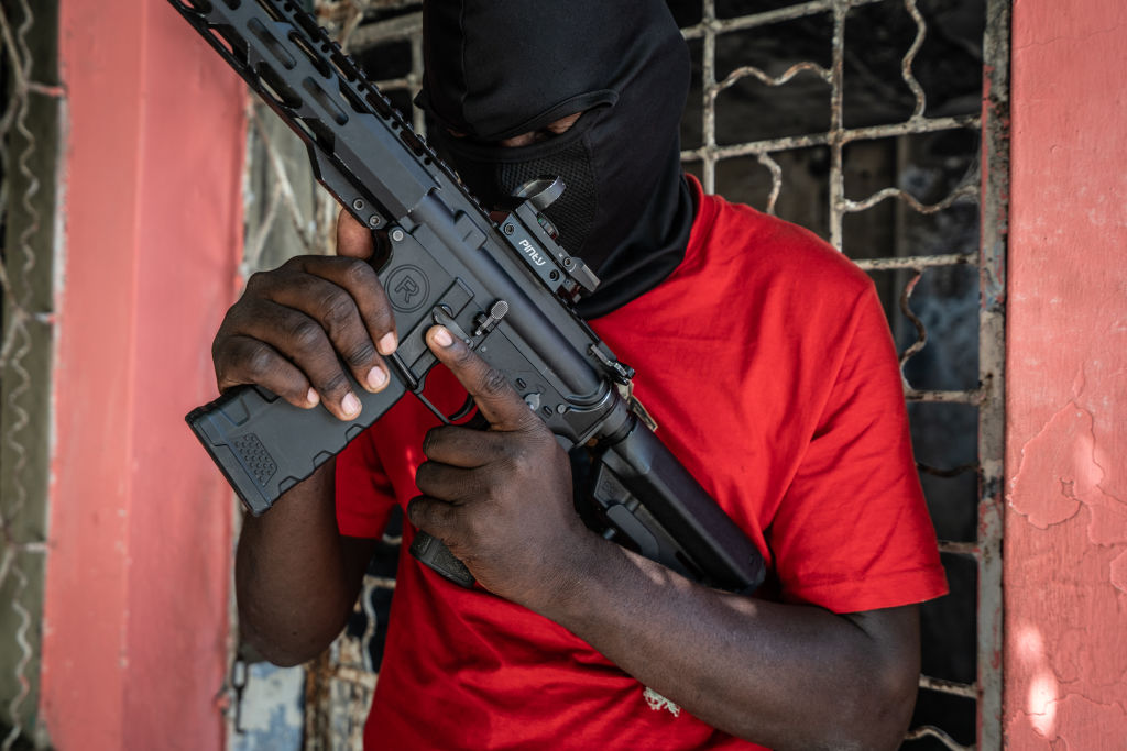 A gang member stands guard in the Delmas 3 area of Port-au-Prince, Haiti, on February 22, 2024. (Photo by Giles Clarke/Getty Images)