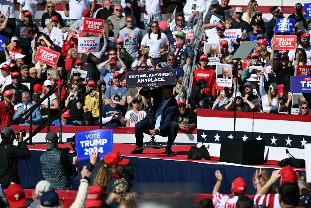 A staff member of former President Donald Trump places a sign calling for a debate between Trump and President Joe Biden during a campaign rally in Wildwood, New Jersey, on May 11, 2024. (Photo by JIM WATSON/AFP via Getty Images)