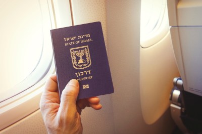 Passenger holding Israeli passport on the airplane