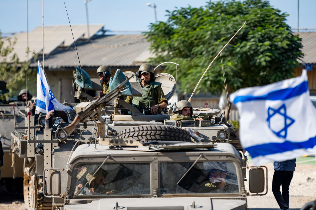 IDF soldiers ride in armored personnel carriers in Be'eri, Israel, on October 17, 2023. (Photo by Alexi J. Rosenfeld/Getty Images)