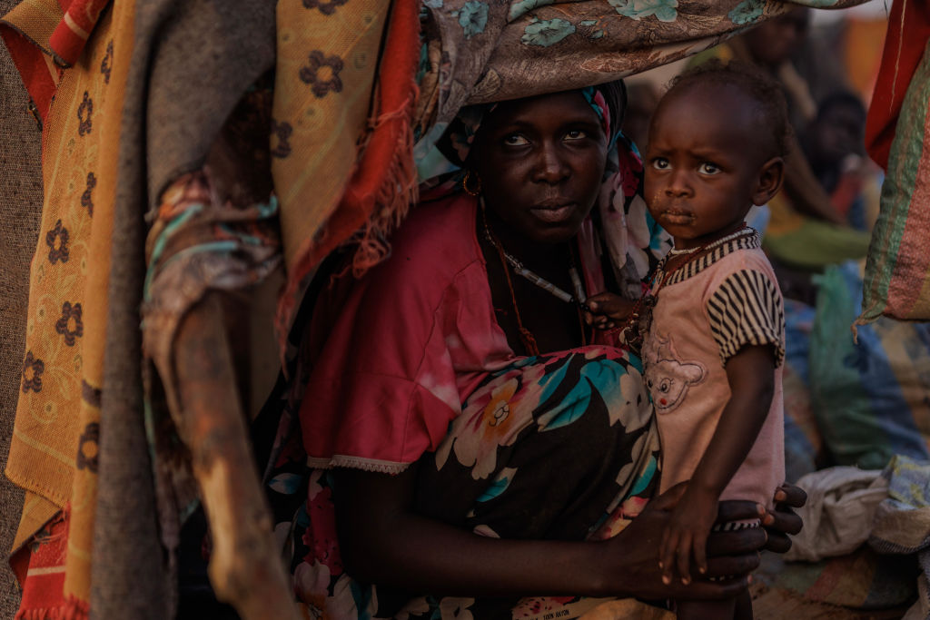 A 19-year-old woman and her 1-year-old child, who fled from their village of Kandobe in Darfur, Sudan, are photographed in Adre, Chad, on April 19, 2024. (Photo by Dan Kitwood/Getty Images)