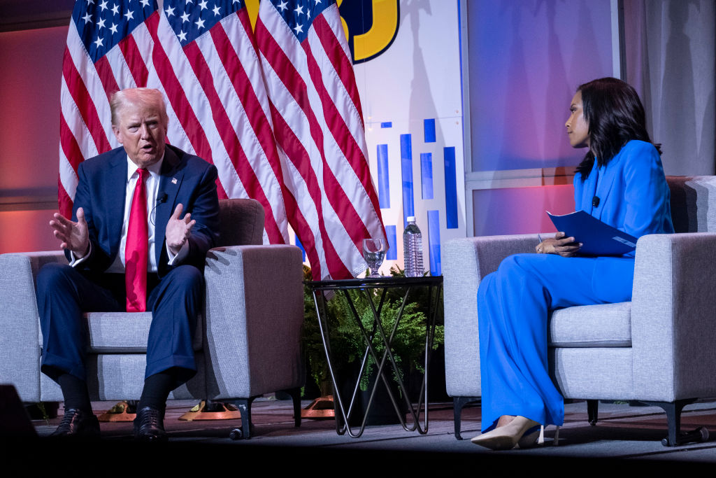 Republican presidential nominee Donald J. Trump, left, and Rachel Scott, senior congressional correspondent for ABC News, right, attend a Q&A on the opening day of the National Association of Black Journalists (NABJ) Annual Convention in Chicago, Illinois, on Wednesday, July 31, 2024. (Photo by Joel Angel Juarez/Washington Post/Getty Images)