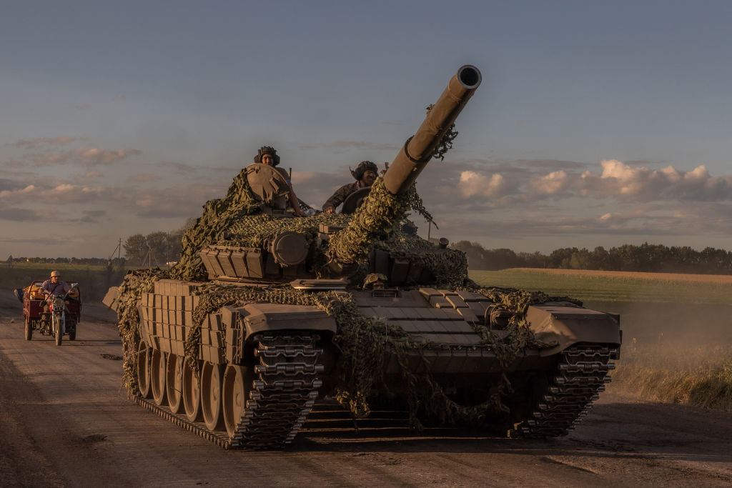 Ukrainian service members operate a Soviet-made T-72 tank in the Sumy region, near the border with Russia, on August 12, 2024. Ukraine launched a surprise offensive into the Russian border region of Kursk on August 6, 2024. (Photo by Roman Pilpey/AFP/Getty Images) 