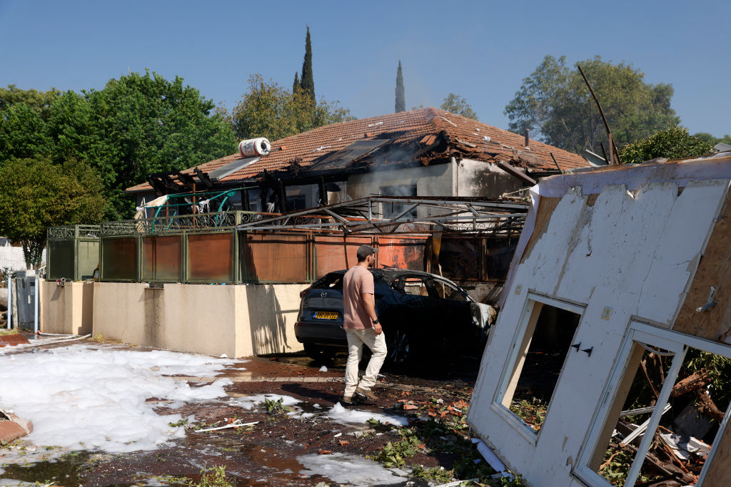 A man inspects the damage at the site of a rocket attack, launched from southern Lebanon, in the town of Katzrin in the Israel-annexed Golan Heights on August 21, 2024. (Photo by JALAA MAREY/AFP via Getty Images)