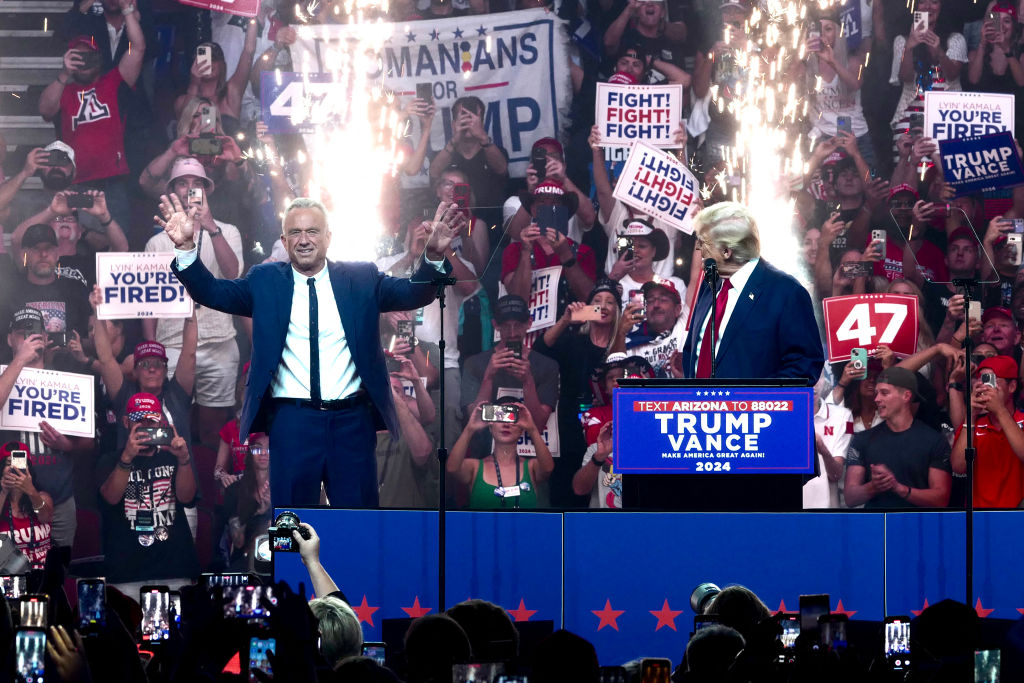 Former President Donald Trump welcomes onstage Independent presidential candidate Robert F. Kennedy Jr. in Glendale, Arizona, on August 23, 2024. (Photo by OLIVIER TOURON/AFP via Getty Images)