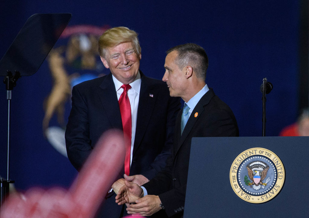 Corey Lewandowski speaks as then-President Donald Trump looks on during a rally at Total Sports Park in Washington, Michigan, on April 28, 2018. (Photo credit should read MANDEL NGAN/AFP via Getty Images)