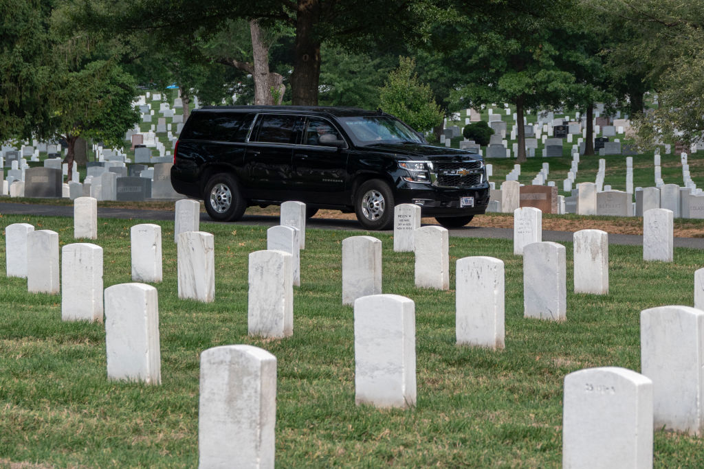 Donald Trump rides in a SUV through Arlington National Cemetery after a wreath-laying ceremony at the Tomb of the Unknown Soldier honoring the lives of those who died at the Abbey Gate bombing, on August 26, 2024, in Arlington, Virginia. (Photo by Kevin Carter/Getty Images)