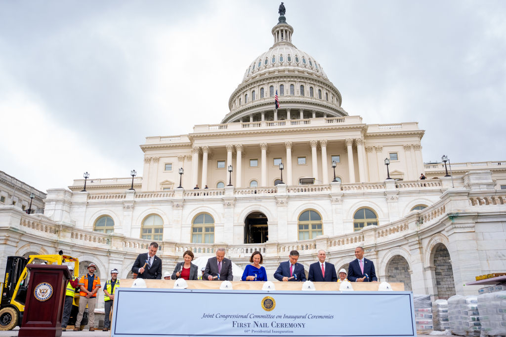 Architect of the U.S. Capitol Thomas Austin, Sen. Amy Klobuchar, Senate Majority Leader Chuck Schumer, Sen. Deb Fischer, House Speaker Mike Johnson, House Majority Leader Steve Scalise, and House Minority Leader Hakeem Jeffries participate in the first nail ceremony for the construction of the 2025 presidential inauguration platform on the West Front of the U.S. Capitol Building in Washington, D.C., on September 18, 2024. (Photo by Andrew Harnik/Getty Images)