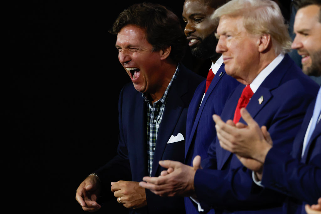 Tucker Carlson, Rep. Byron Donalds, former President Donald Trump, and Sen. J.D. Vance  appear on the first day of the Republican National Convention on July 15, 2024, in Milwaukee, Wisconsin. (Photo by Chip Somodevilla/Getty Images)