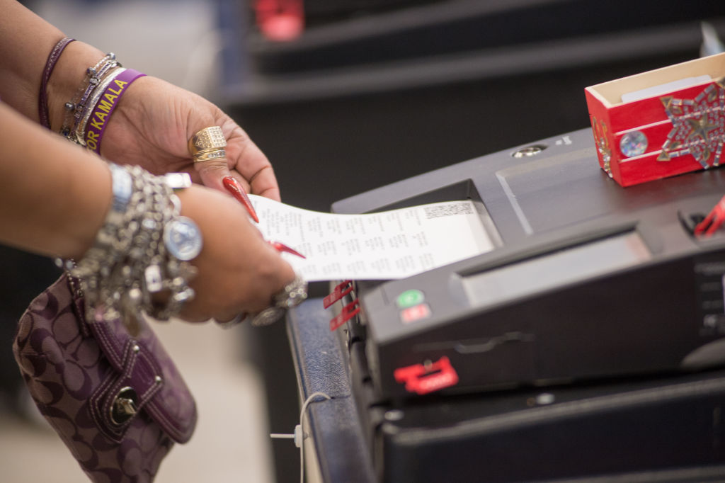 A voter casts their ballot during early voting for the presidential general election at the Voting Supersite in Downtown Chicago, Illinois on October 3, 2024. Voters can cast their ballots in one of 12 languages. (Photo by Jacek Boczarski/Anadolu via Getty Images)