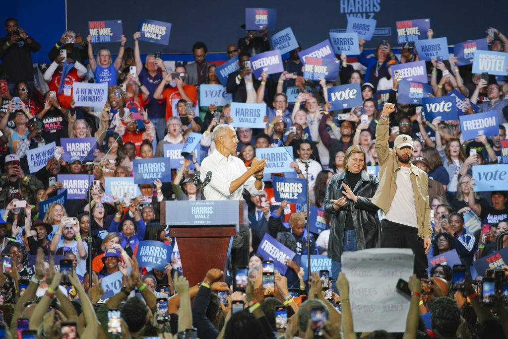 Former President Barack Obama and American rapper Eminem greet the crowd in support of Vice President Kamala Harris's 2024 presidential campaign in Detroit, Michigan, on October 22, 2024. (Photo by Katie McTiernan/Anadolu via Getty Images)