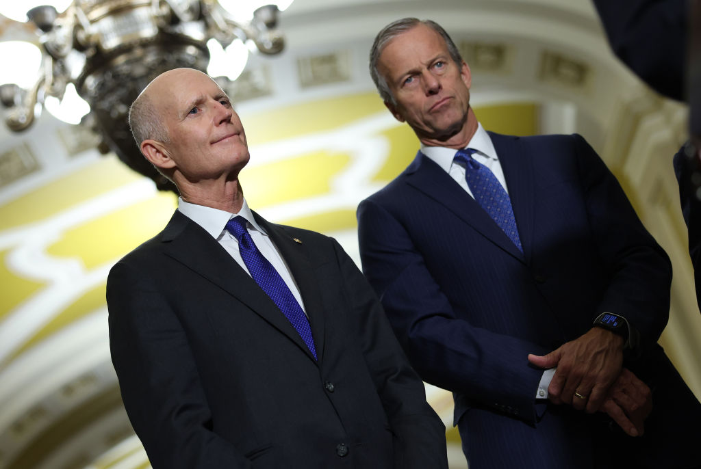 Sen. Rick Scott of Florida and Sen. John Thune of South Dakota wait to speak to reporters at the U.S. Capitol on December 6, 2022, in Washington, D.C. (Photo by Kevin Dietsch/Getty Images)