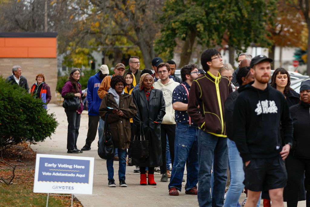 People wait in line during early voting at a polling station at Ottawa Hills High School in Grand Rapids, Michigan, on November 3, 2024. (Photo by KAMIL KRZACZYNSKI/AFP via Getty Images)