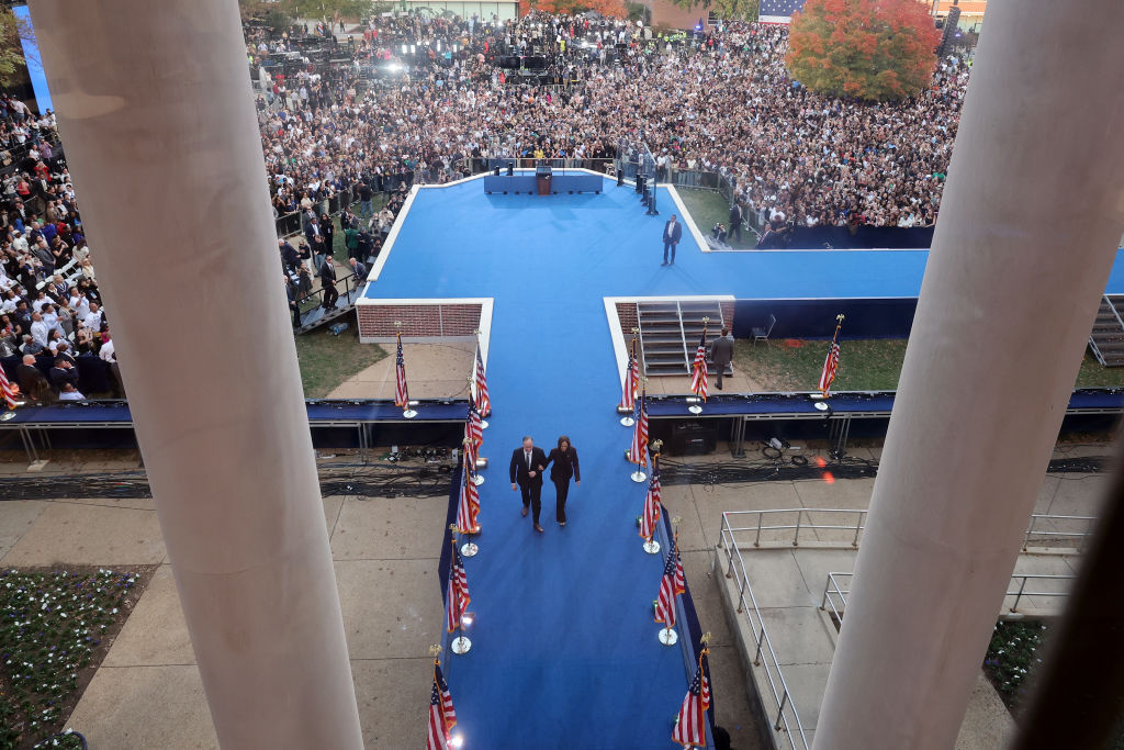 Vice President Kamala Harris departs the stage at Howard University with husband Doug Emhoff after giving her concession speech on November 6, 2024 ,in Washington, D.C. (Photo by Kevin Dietsch/Getty Images)