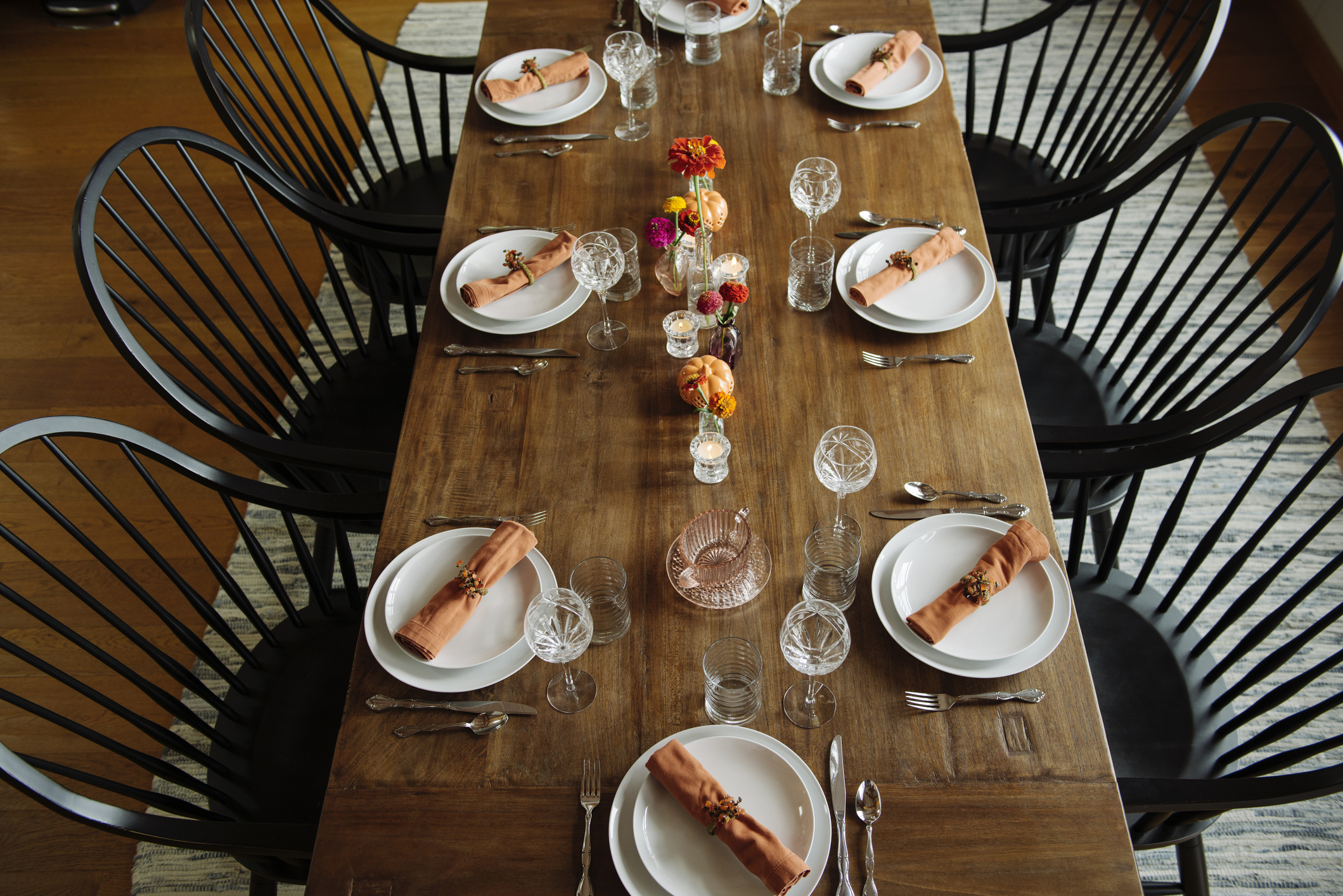 Plates with wineglasses arranged on dinner table in dining room