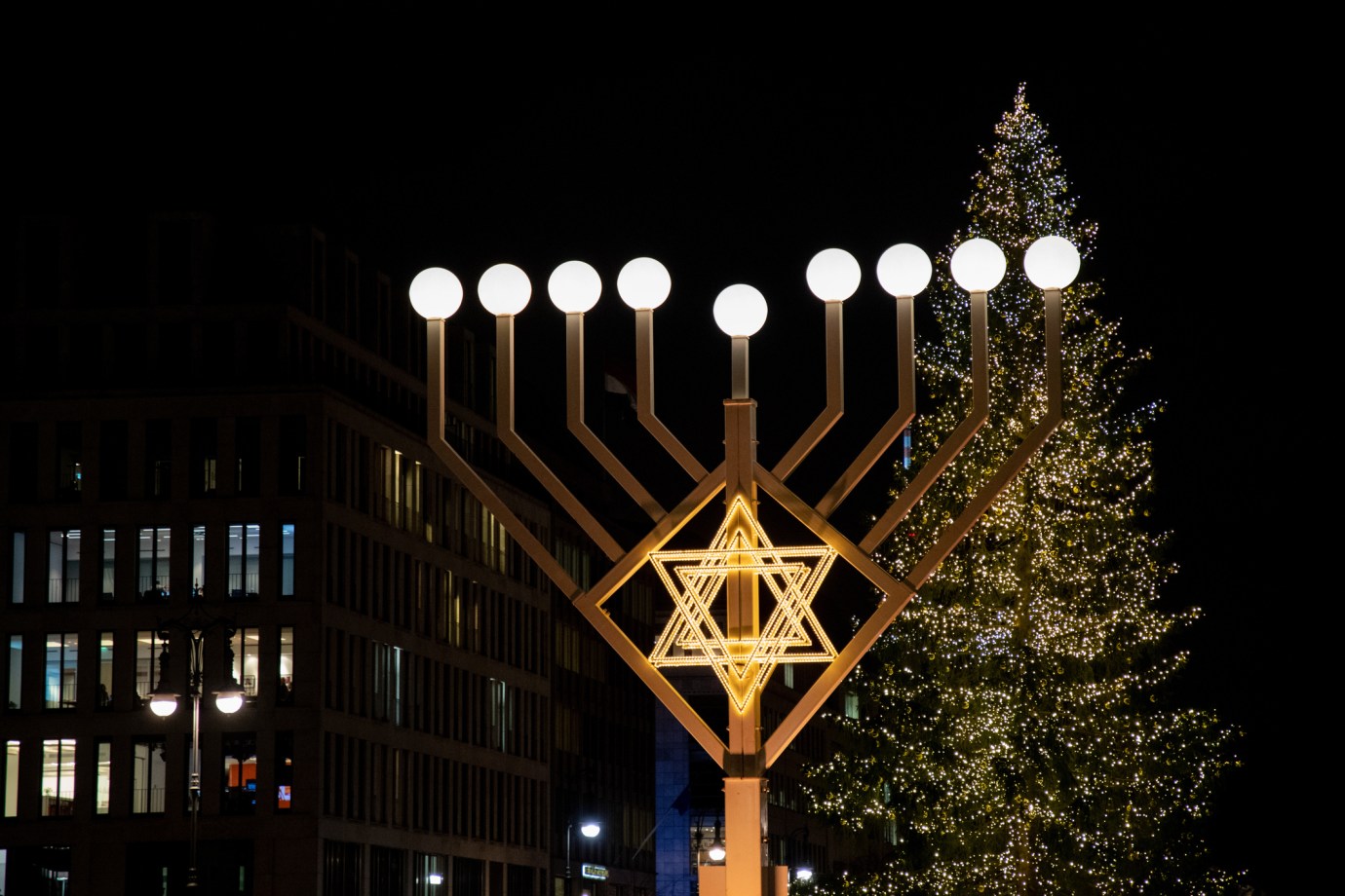 A menorrah stands in front of a Christmas tree in Berlin, Germany. (Photo via Getty Images) 