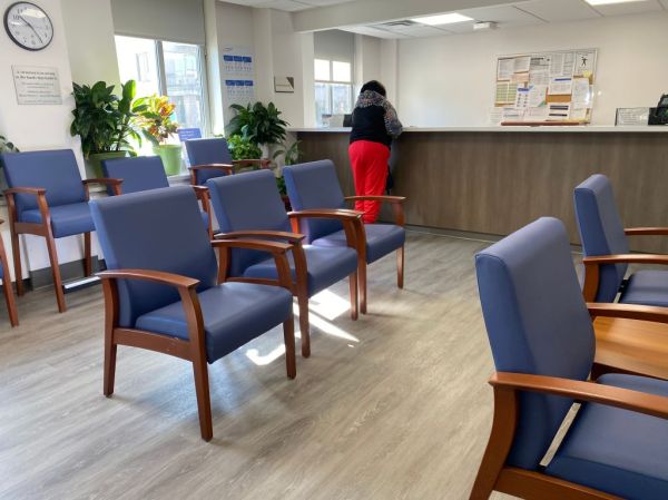 Woman, reception desk, doctors office, waiting room, Lenox Hill Hospital, Manhattan, New York, hospital, chair, seating, clock, one person