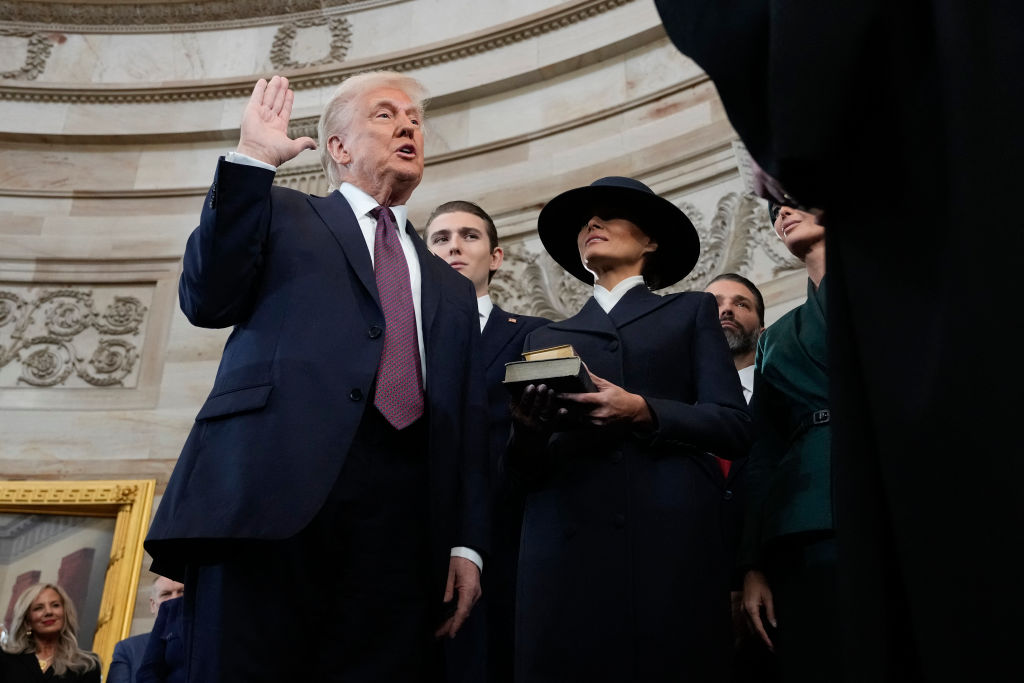 Donald Trump is sworn in as the 47th president of the United States by Chief Justice John Roberts as Melania Trump holds the Bible on Jan. 20, 2025. (Photo by MORRY GASH/POOL/AFP via Getty Images)