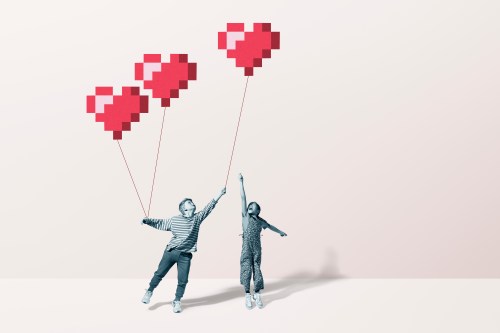 Boy and girl catching red heart balloons
