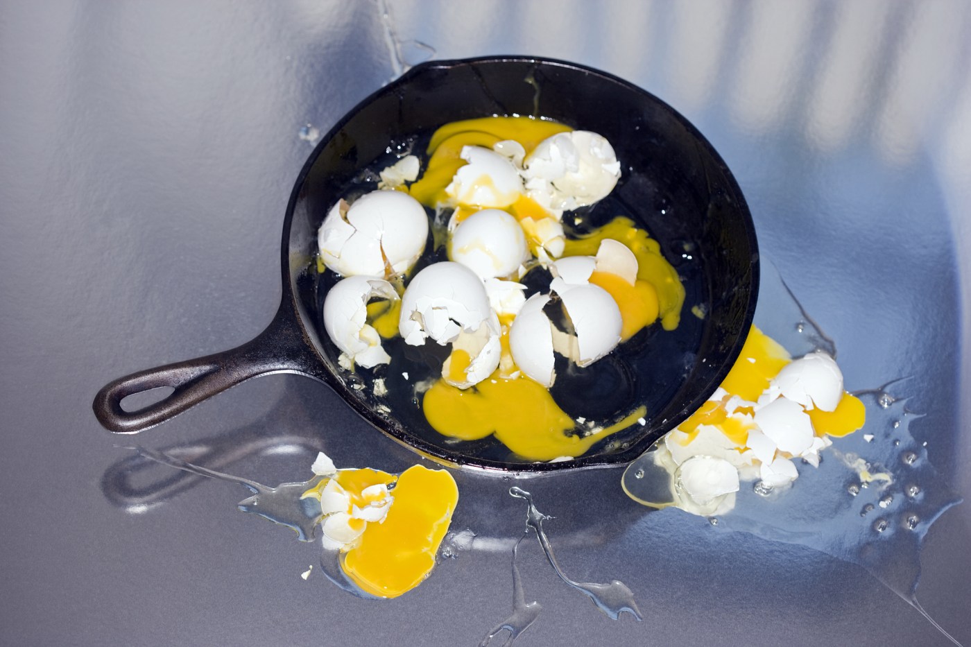 Mess of broken eggs in pan
