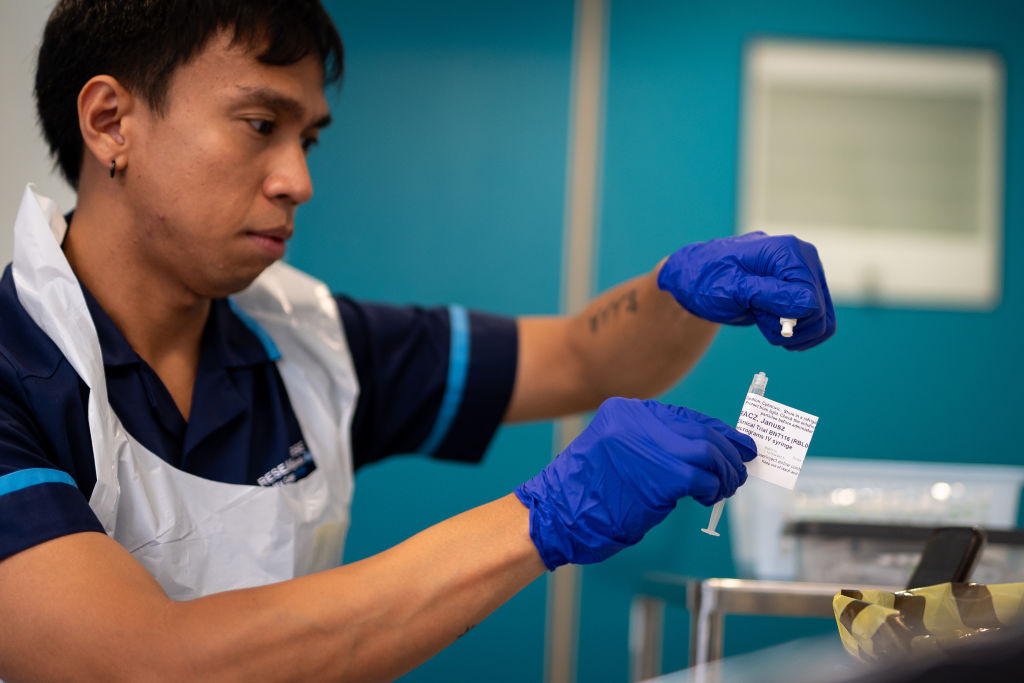 A research nurse holds an injection of a BioNTech mRNA cancer immunotherapy for non-small cell lung cancer. (Photo by Aaron Chown/PA Images via Getty Images)
