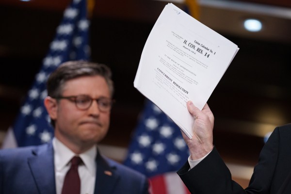 House Majority Leader Rep. Steve Scalise, accompanied U.S. Speaker of the House Rep. Mike Johnson, holds up their budget resolution bill on February 25, 2025. (Photo by Andrew Harnik/Getty Images)