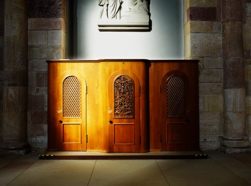confession booth illuminated by rays of the sun