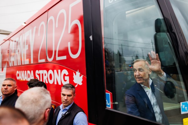 Liberal Party leader Mark Carney waves to supporters outside a pub as he leaves a campaign stop in Halton Hills, Ontario, Canada, on March 31, 2025. (Photo by Cole Burston/Getty Images)