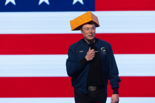 Elon Musk arrives for a town hall in Green Bay, Wisconsin, wearing a cheesehead hat on March 30, 2025. (Photo by Scott Olson/Getty Images)