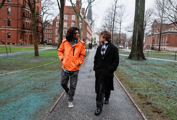 Two international Harvard University students, Abdullah Shahid Sial, left, and Leo Gerdén, walk through Harvard Yard on April 12, 2025. (Photo by Erin Clark/The Boston Globe via Getty Images)