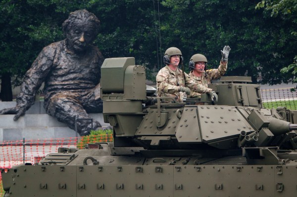 With the Albert Einstein Memorial statue in the background, members of the U.S. Army ride in a Bradley Fighting Vehicle during the 250th birthday parade on June 14, 2025, in Washington, D.C. (Photo by Kevin Carter/Getty Images)