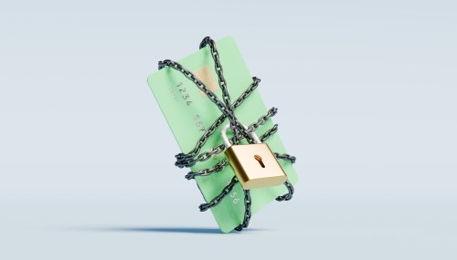 Green credit card wrapped in a chain with a lock