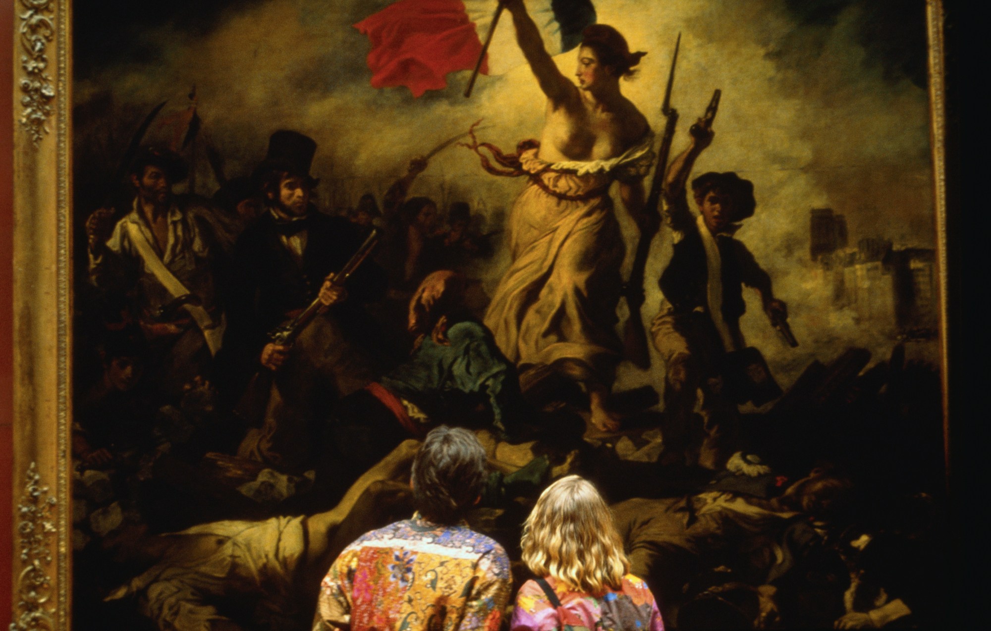 A couple views 'Liberty Leading the People' by Eugene Delacroix. (Photo by Farrell Grehan via Getty ...