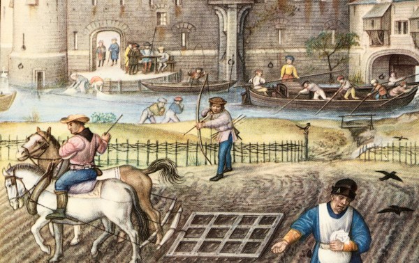 Peasants at work before the gates of a town, circa late 15th century. (Photo via Getty Images)
