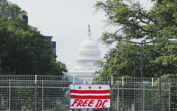 The U.S. Capitol is seen behind a Free DC sign on August 12, 2025 in Washington, DC. (Photo by Kevin Dietsch/Getty Images)