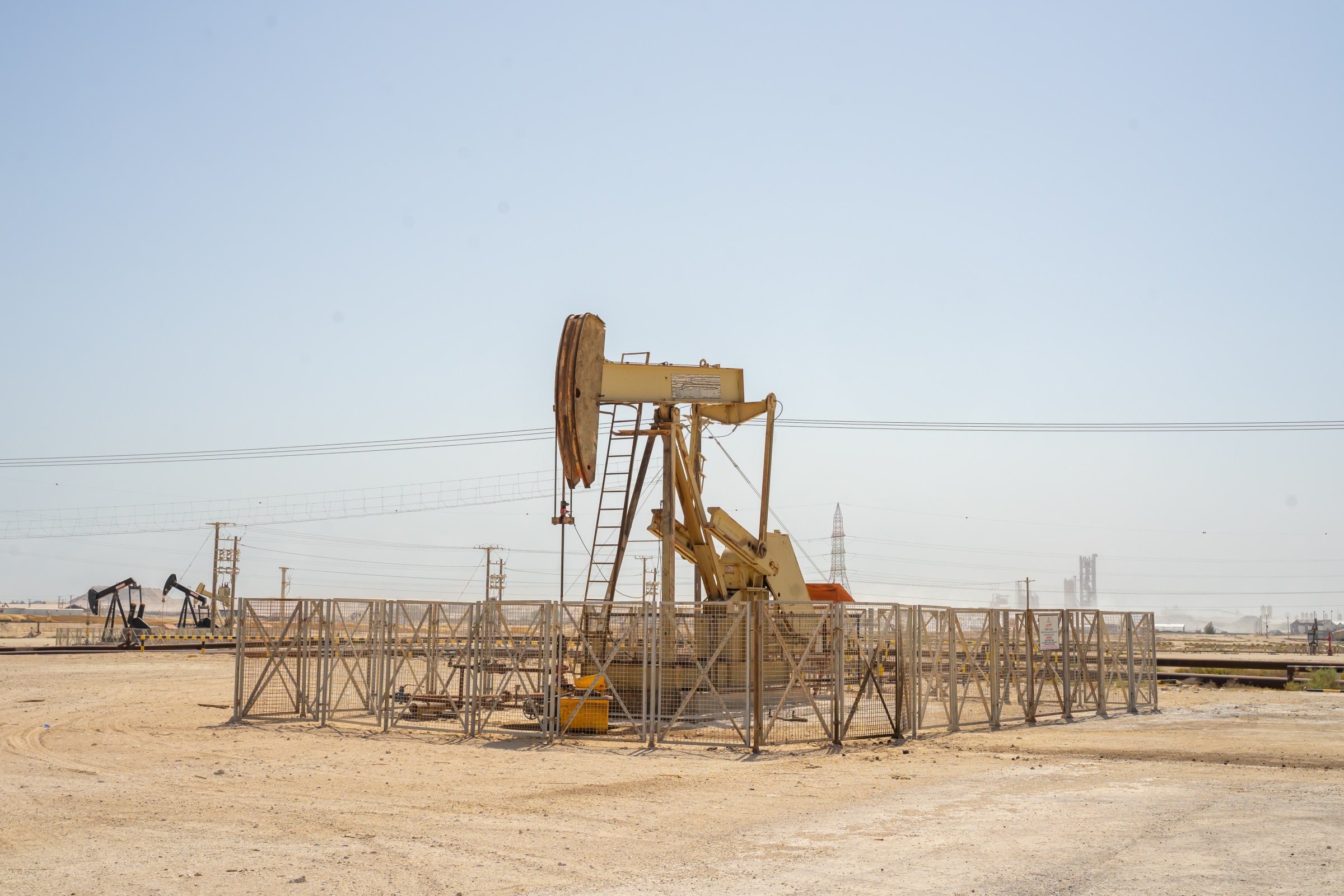 Pump jack, oil horse, oil jack, beam pump extracting crude oil from oil well in the Bahrain desert